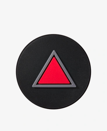 Black circular object with a red triangle in the center on a white background